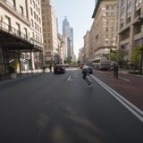 Street Skater Effortlessly Maneuvers New York City's Chaotic Traffic With Sidewalk Slides And Backward Glides
