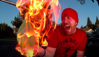 Guy Sets His Hand On Fire, Tests To See If That Will Pop A Water Balloon